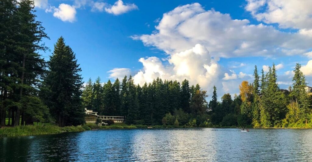 View of Lake Wilderness surrounded by trees and a lodge in Maple Valley, WA